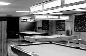 The original Gold Crown pool room — twelve tables under fluorescent lights