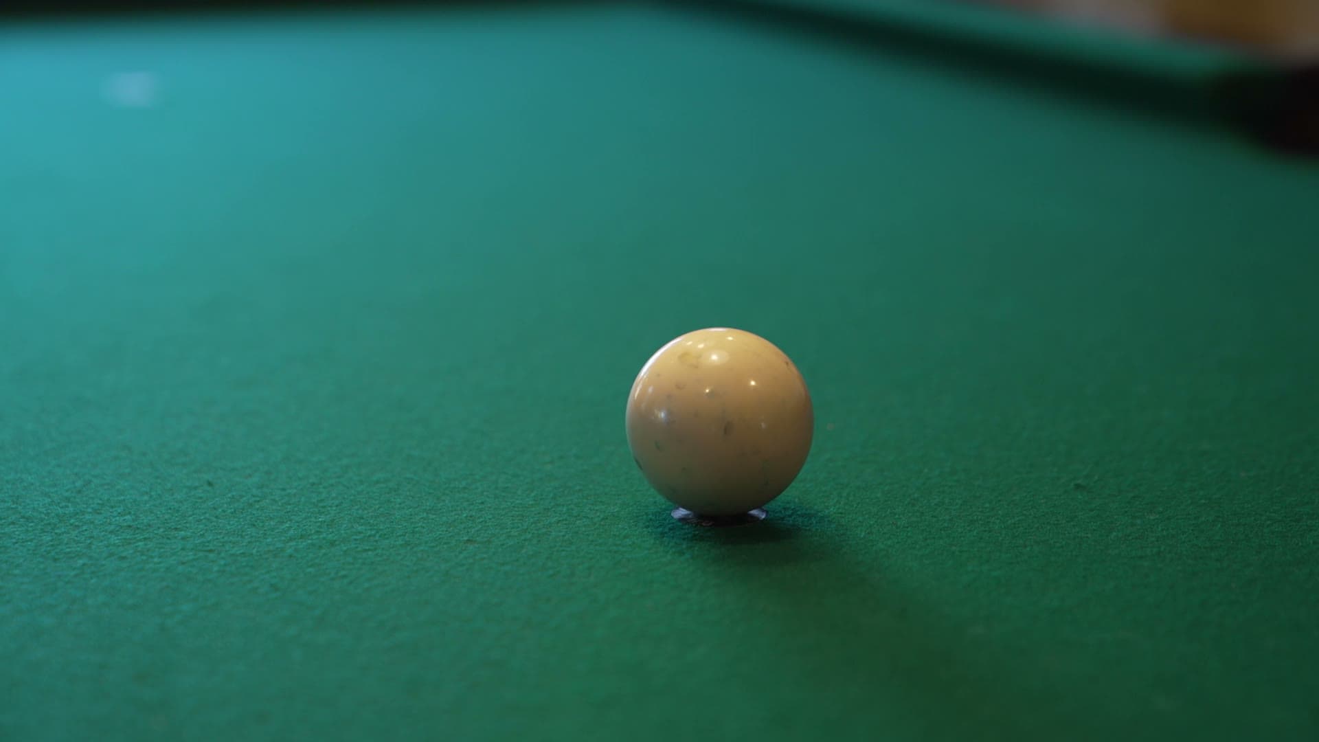 A ball struck across the felt