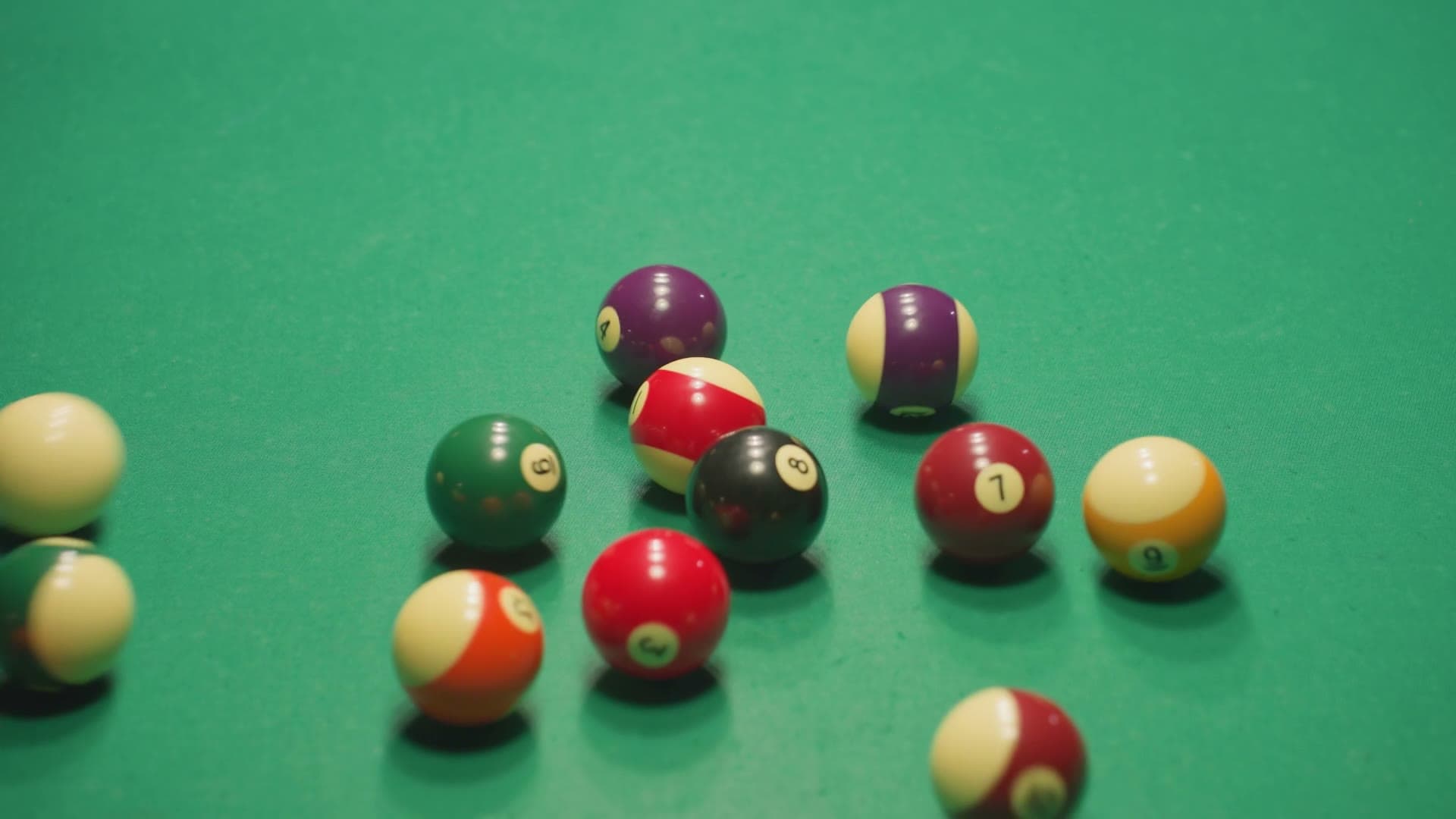 Scattered billiard balls on green table
